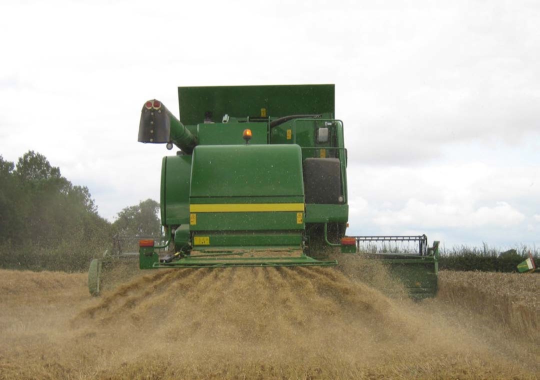 Straw being chopped and spread on a field